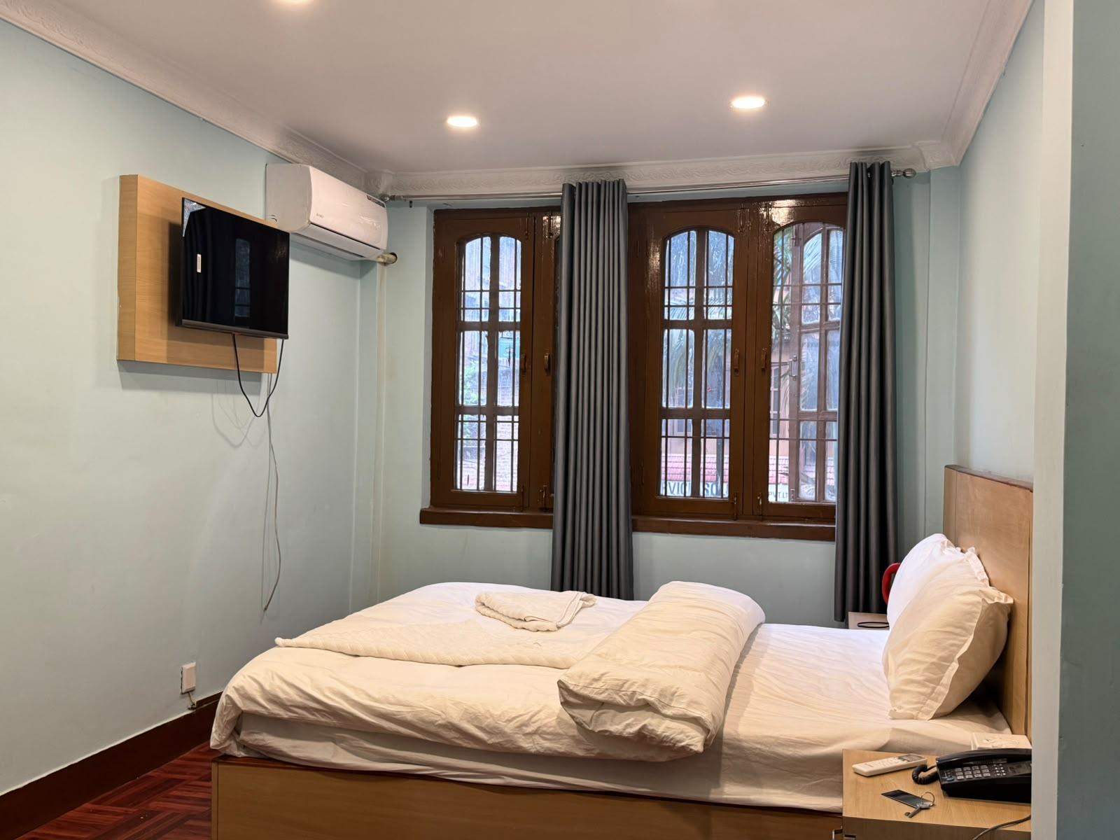 Deluxe Double Room bed and furnishings at Hotel Yak and Trek Thamel in Kathmandu